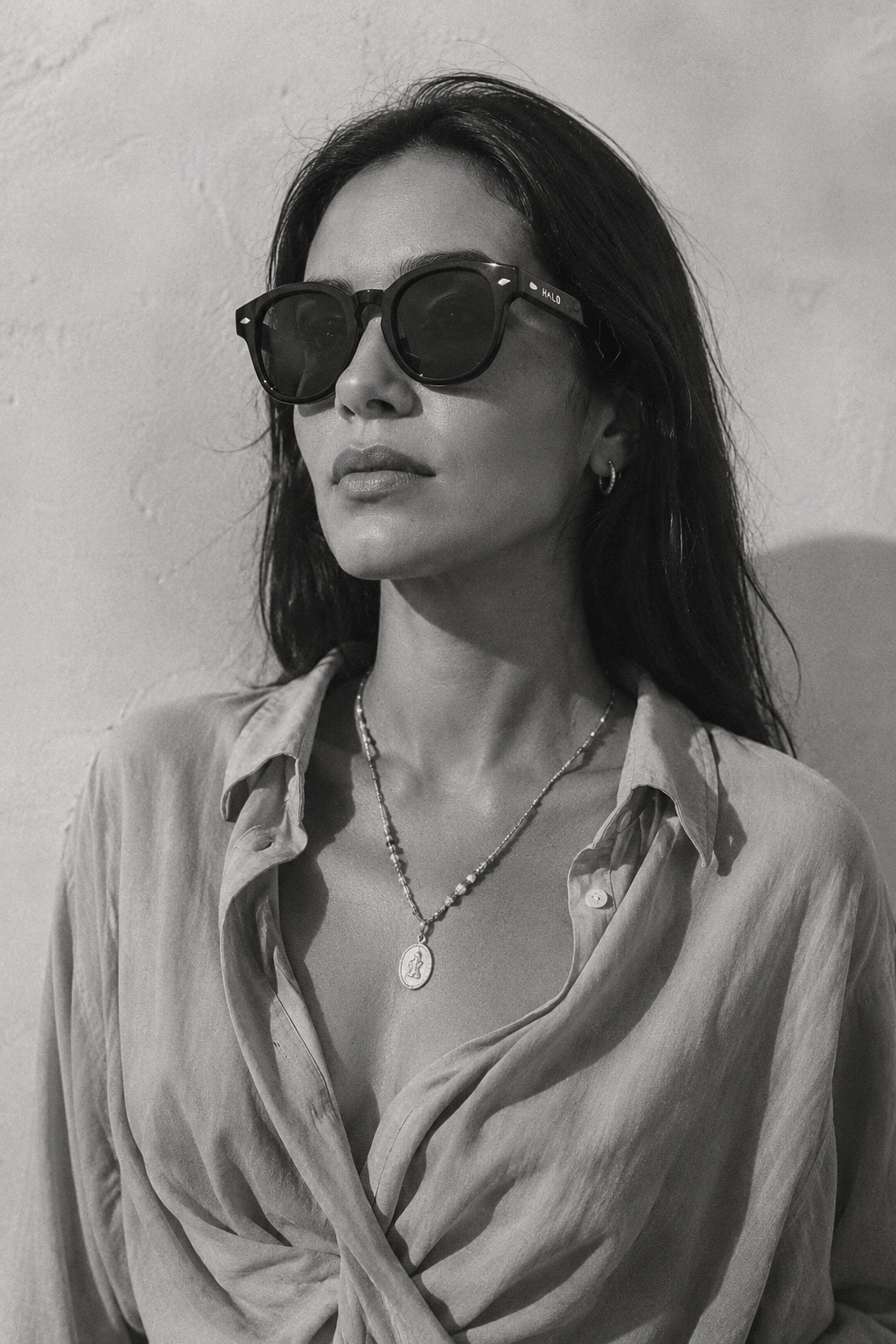 Model wearing HALO Phoenix eclipse glasses in daylight with a linen shirt, showing the frame's everyday afterlife beyond the solar eclipse